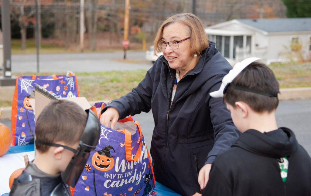 Gerri McAndrew handing out candy to children